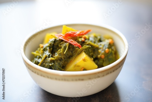 close-up of saag aloo, vibrant spinach and potatoes