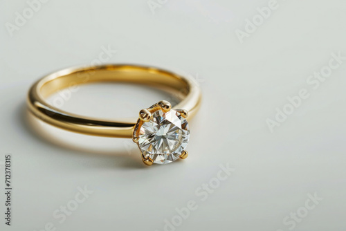 gold engagement ring with gemstone, on white background