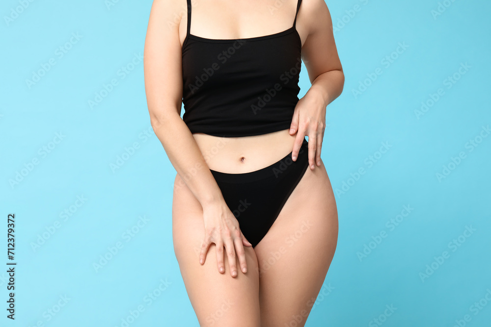 Body positive young woman in underwear on blue background, closeup Body positive young woman in underwear on blue background, closeup