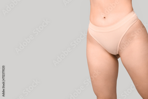 Body positive young woman in underwear on light background, closeup