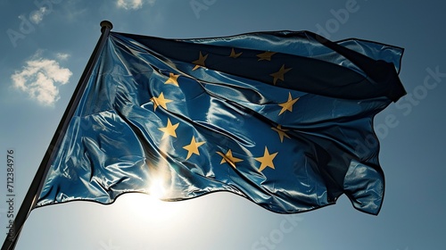 The flag of EU flutters in the wind against a bright blue sky. Created with Generative Ai technology. photo