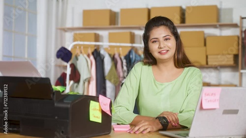 happy businesswoman at ecommerce warehouse confidently looking at camera - concept empowerment, small business owner and retail seller