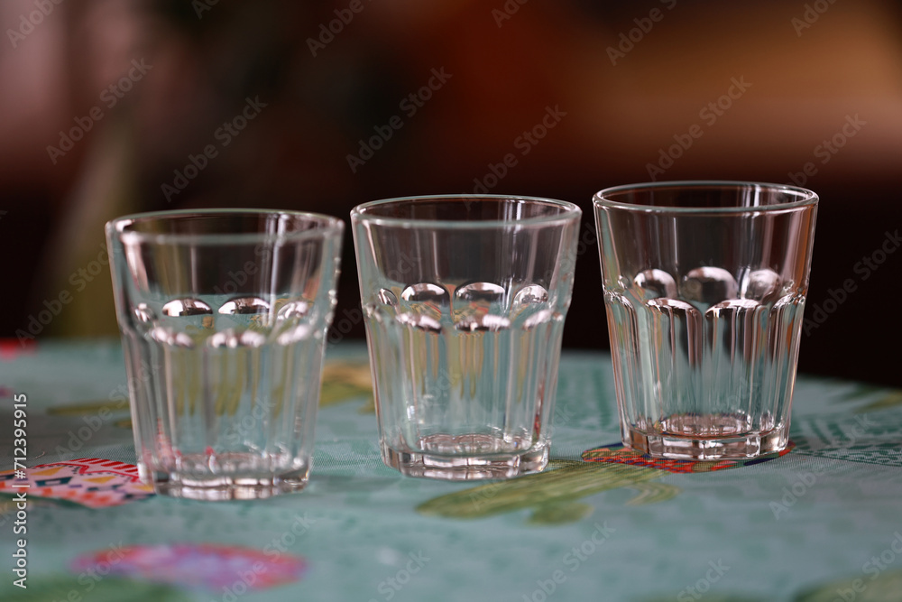 Three glasses of water on the kitchen table. Three glasses of water on the kitchen table.