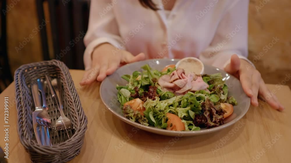 Woman hands spinning bowl with salad in restaurant ready to eat. Girl hands eating out in favourite place ordering salad. Food concept. Woman hands spinning bowl with salad in restaurant ready to eat. Girl hands eating out in favourite place ordering salad. Food concept.