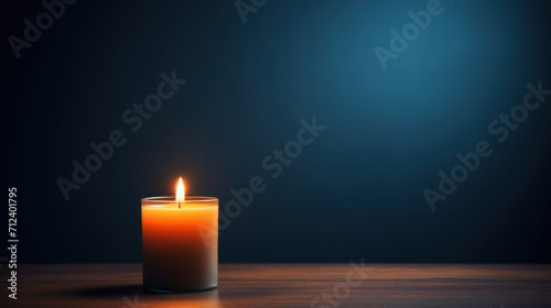Candlelight on wooden table against blue backdrop