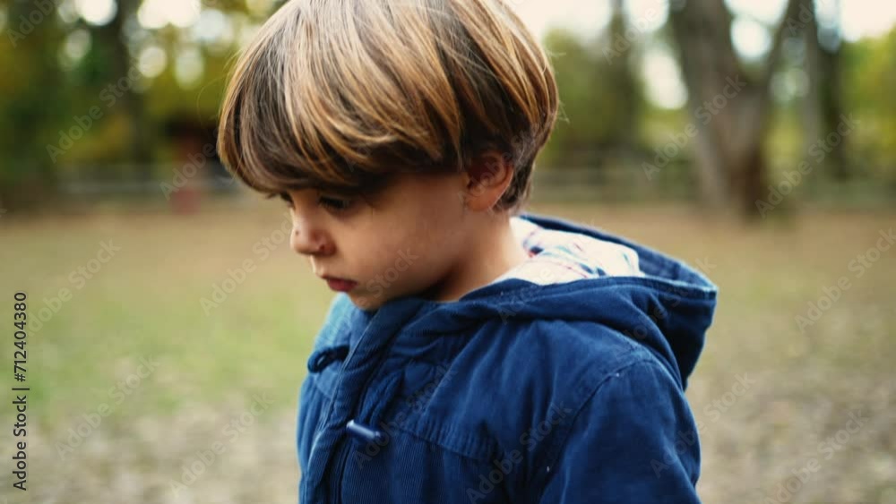 Introspective 4-Year-Old Boy Daydreaming While Walking in Forest Park Introspective 4-Year-Old Boy Daydreaming While Walking in Forest Park