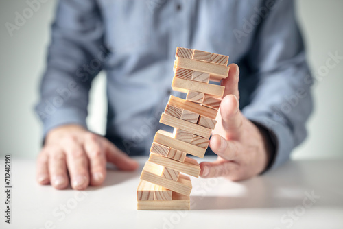 Planning, insurance, risk and strategy in business, man holding up falling tower