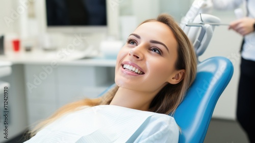 A smiling girl blonde sits in a blue chair at a dentist s appointment  banner