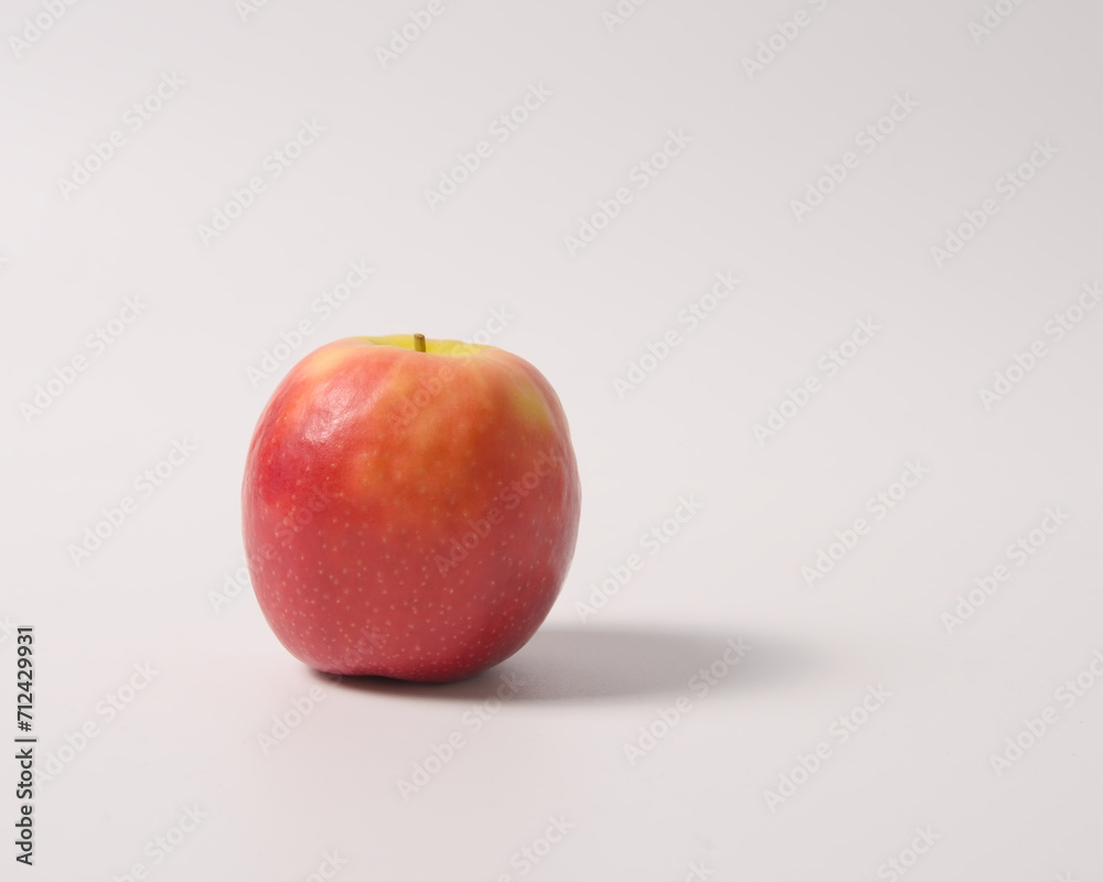 An apple with shadow isolated on white background. An apple with shadow isolated on white background.