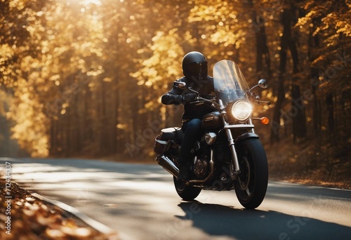 A motorcycle rider speeding on a autumn road