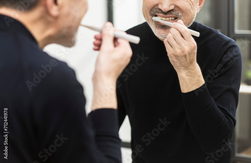 歯磨きをする50代日本人男性 photo