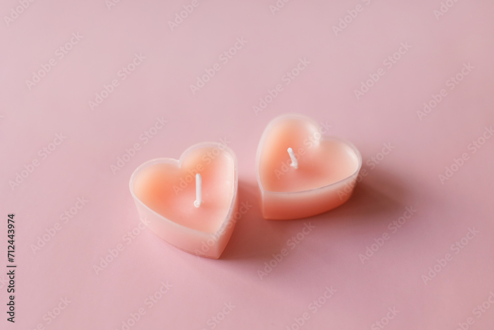 pair of candles tablets in shape of heart. valentine's day. minimal background pair of candles tablets in shape of heart. valentine's day. minimal background