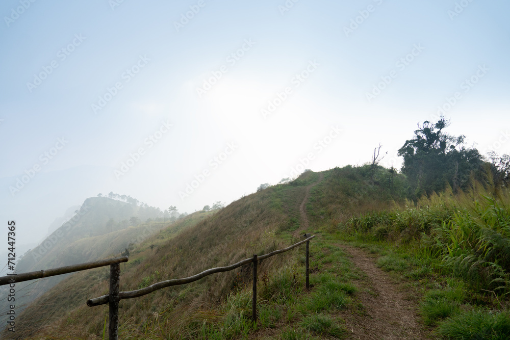 Landscape view of mountain. The sky is lightly covered with fog and protection of fence. Route heading towards to Phu Nom. At Phu Langka Phayao Province of Thailand. 