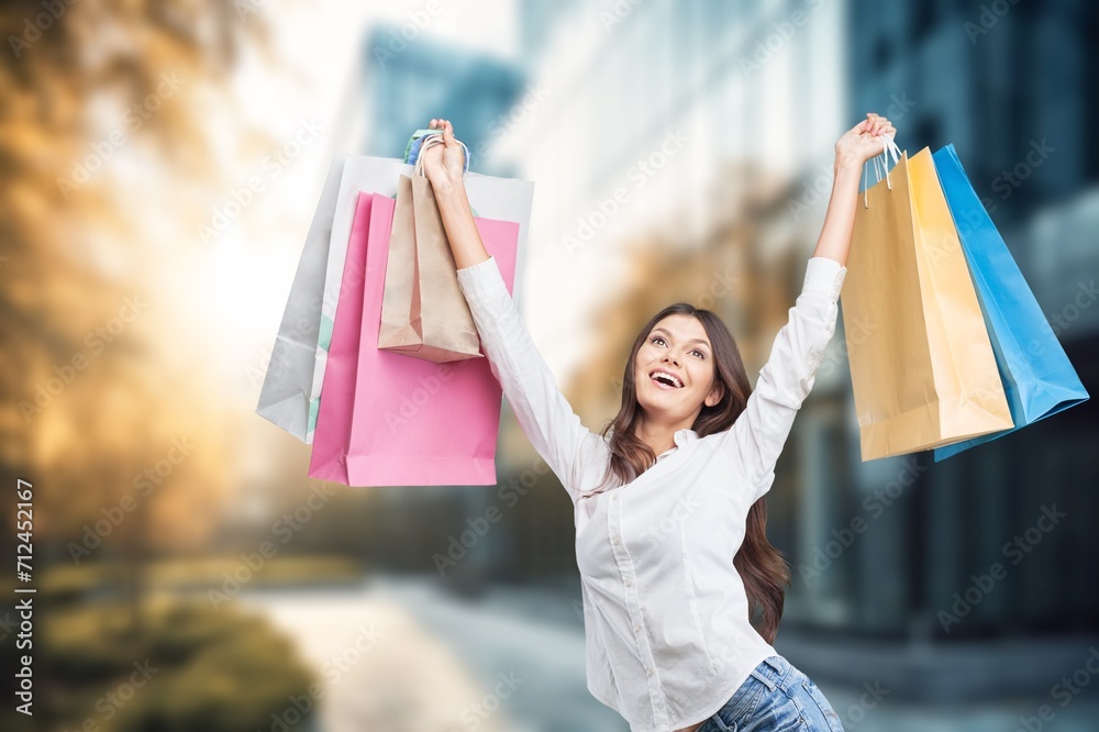 Cheerful young woman with set of shopping bags. Cheerful young woman with set of shopping bags.
