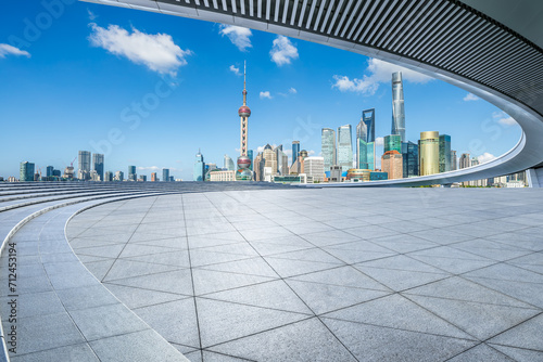 Empty square floor and pedestrian bridge with city buildings scenery in Shanghai