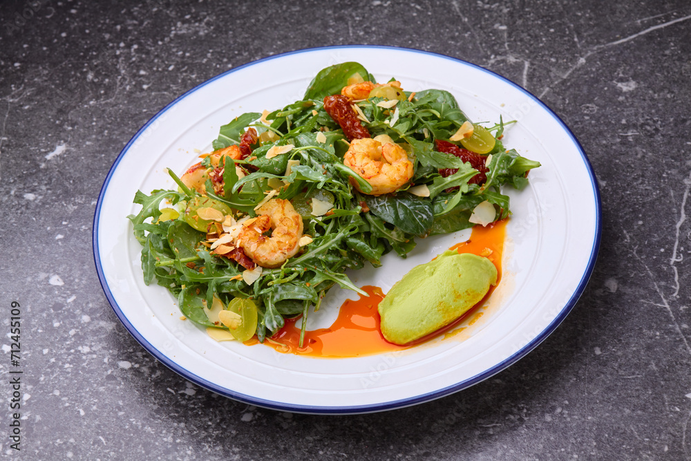 fresh healthy shrimps salad with arugula,dried tomatoes and grapes. fresh healthy shrimps salad with arugula,dried tomatoes and grapes.
