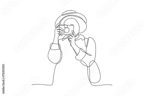 Single one line drawing a girl who likes traveling and taking photos. Travel, vacation, holidays and adventure. Mountain landscape. Continuous line draw design graphic vector illustration