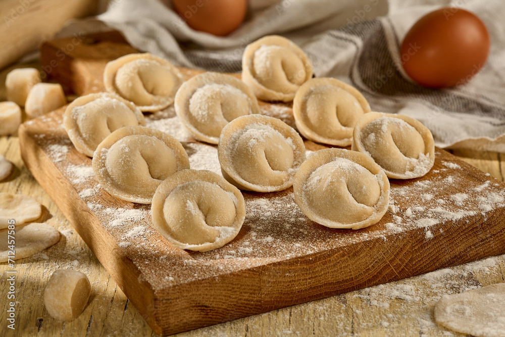 Pelmeni on a wooden board, a rustic scene showcasing Slavic culinary traditions Pelmeni on a wooden board, a rustic scene showcasing Slavic culinary traditions