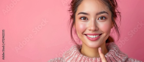 picture of a contented, relaxed, and grinning beauty Asian lady pointing pointer at advertisement banner copyspace to introduce new product photo