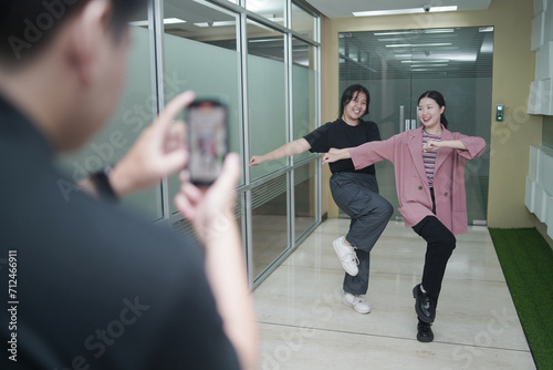 Asian vlogger female influencer dancing making video for having fun on social media IG story reel tiktok . Gen Z people film selfie shooting app viral video.