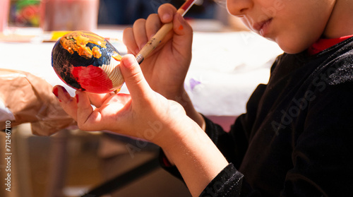 Cuadro en lienzo Child girl painting Easter egg. Child on Easter day