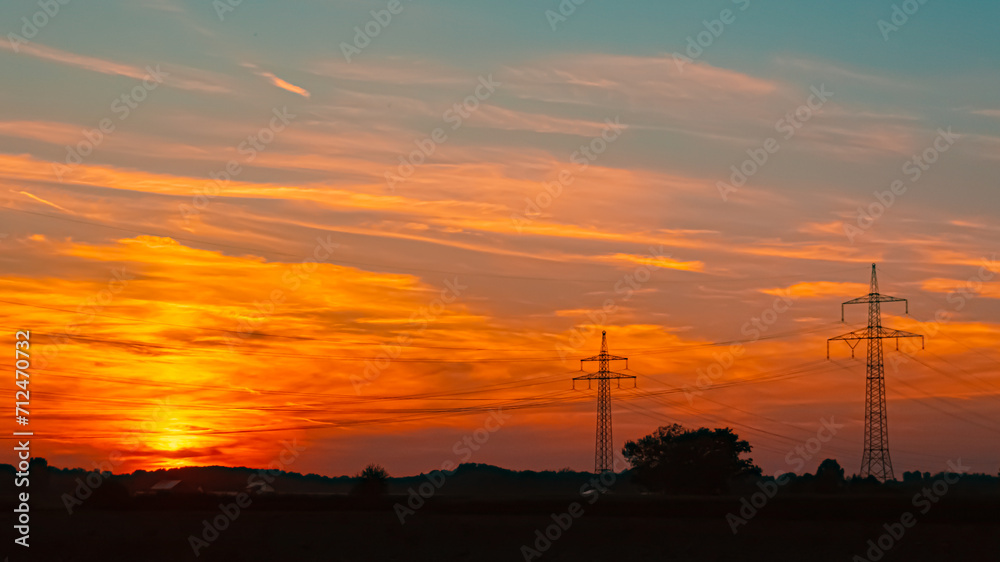Sunset with overland high voltage lines near Aholming, Deggendorf, Bavaria, Germany