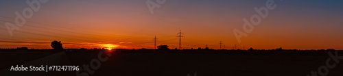 High resolution stitched alpine summer sunset panorama with overland high voltage lines near Aholming, Deggendorf, Bavaria, Germany