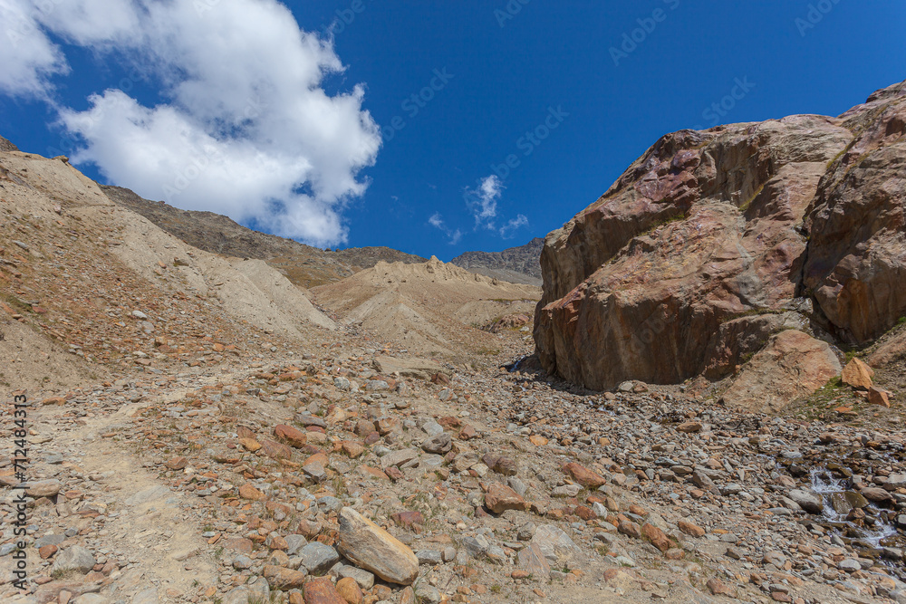 Lunar panorama of rocks and moraines of the 1850 Valleunga glacier advance that indicate its enormous retreat that occurred due to global warming, Alto Adige, Italy