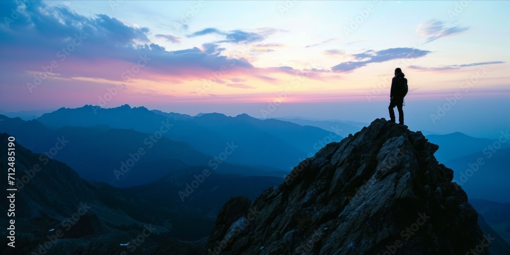 Silhouette of a man on the top of a mountain.Tourist man hiker on top of the mountain. Active life concept, sunset sunrise view