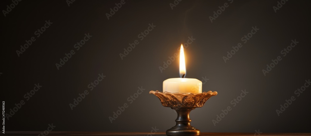 Fototapeta premium Light from a candle and its flickering glow.