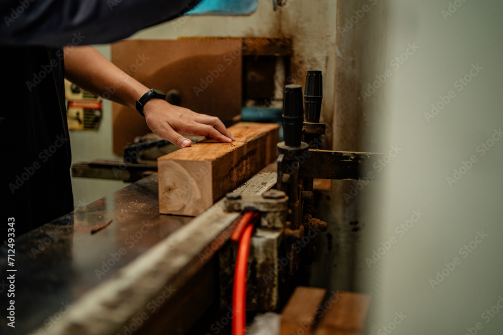 hands workers carpenters working in machines to cut wood timber. man and woman are crafting with wood in a workshop. two craftsmen or handymen working with carpenter tools. hands workers carpenters working in machines to cut wood timber. man and woman are crafting with wood in a workshop. two craftsmen or handymen working with carpenter tools.
