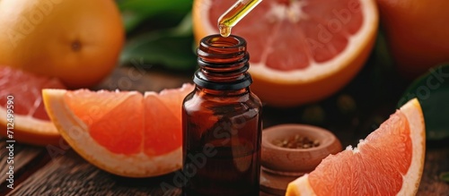 Grapefruit extract in amber bottle with dropper photo