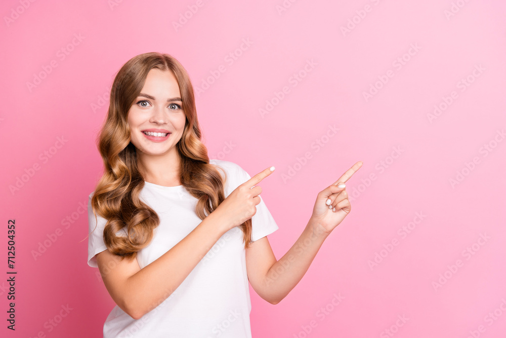 Portrait of young beaming smiling woman wearing white t shirt indicate fingers website subscribe blog isolated on pink color background Portrait of young beaming smiling woman wearing white t shirt indicate fingers website subscribe blog isolated on pink color background
