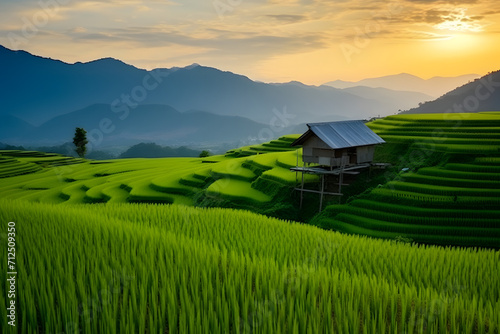 Landscape of rice terrace and hut with mountain range background and beautiful sunrise sky. Nature landscape. Green rice farm. Terraced rice fields. Travel destinations in Chiang Mai, Thailand. photo