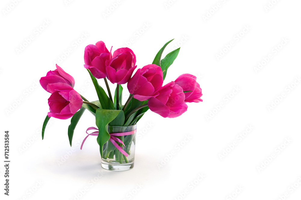 Obraz premium Bouquet pink tulips flowers in glass white vase with space for text on table on a white background with space for text