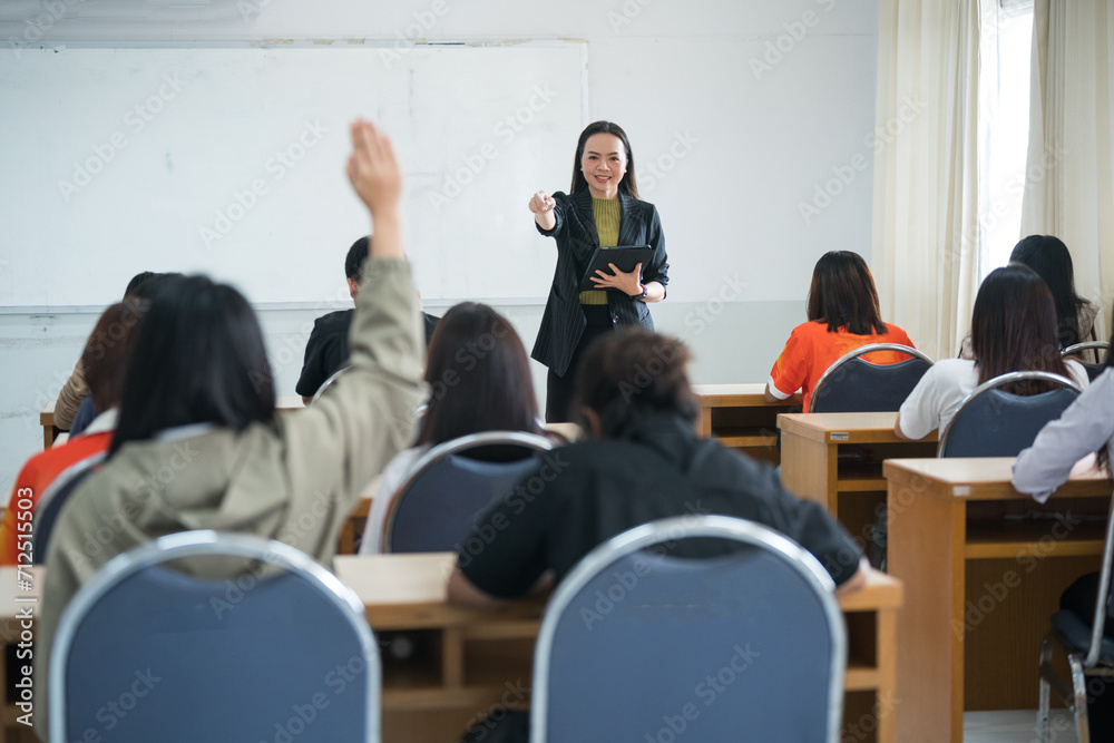 Education, teaching, learning concept. Asian university lecturer teaching lesson to students in classroom Education, teaching, learning concept. Asian university lecturer teaching lesson to students in classroom