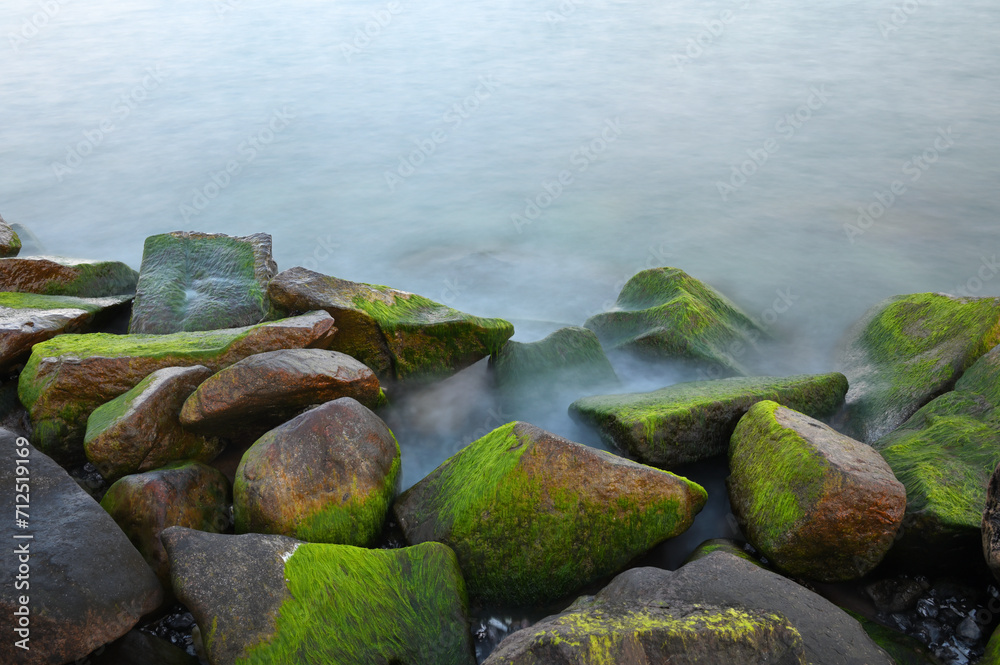 Baltic sea, cold sea water. Waves about stones, Stones with water grass. Coastal stones Baltic sea, cold sea water. Waves about stones, Stones with water grass. Coastal stones