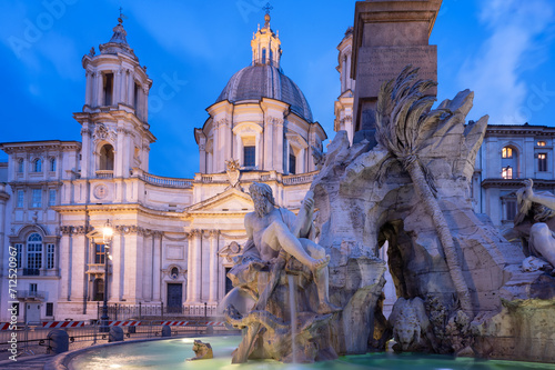 Close up view of the fountain of the four Rivers at illuminated Piazza Navona in blue hour before sunrise, Rome, Italy. photo