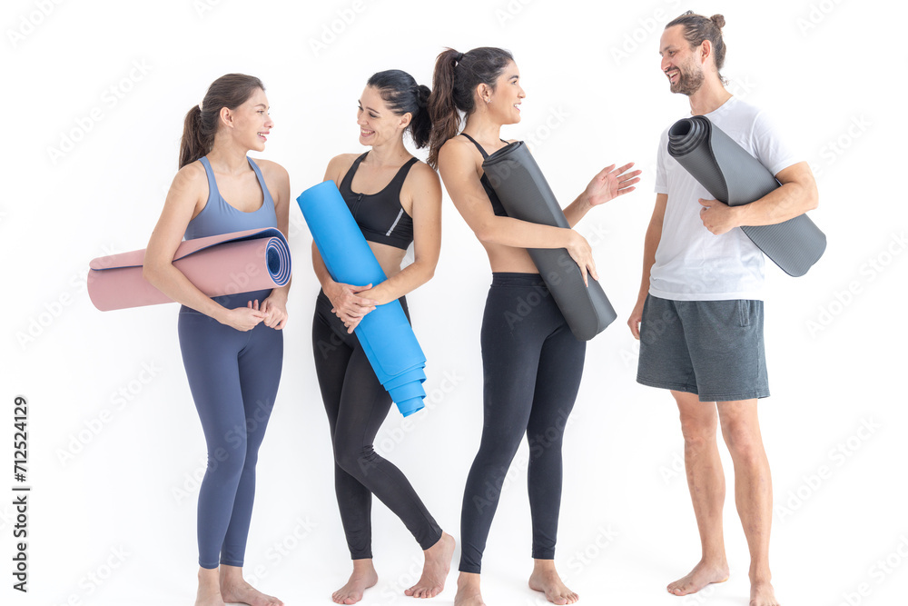 Group of happy sporty women and guy wearing body stylish sportswear holding personal carpets leaned on a white background. waiting for yoga class or body weight class. healthy lifestyle and wellness Group of happy sporty women and guy wearing body stylish sportswear holding personal carpets leaned on a white background. waiting for yoga class or body weight class. healthy lifestyle and wellness