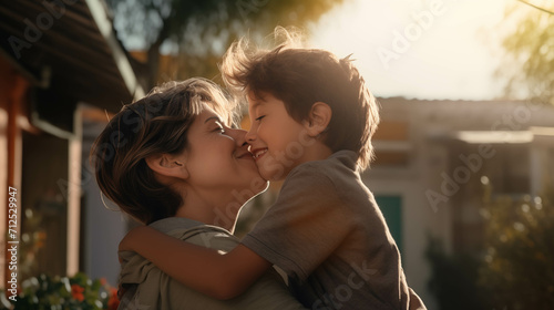 Caucasian boy kisses his mother outside the house.