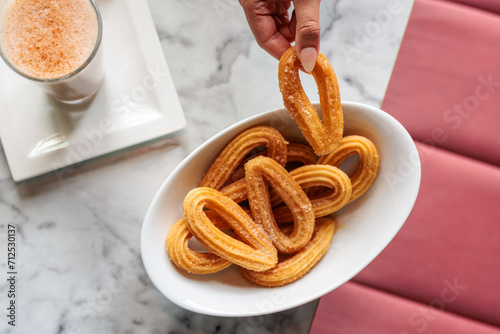 Top view eating vegan cinnamon sugar churros