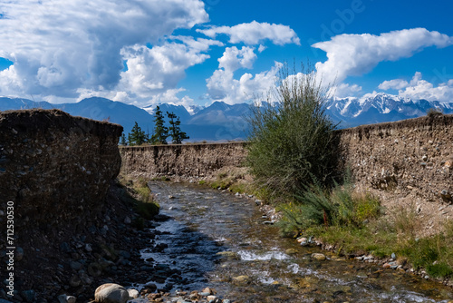 A mountain river in a small crevice on a bright sunny day