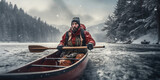 Rafting of a male tourist in a wooden canoe on a river with winter forest on either side.