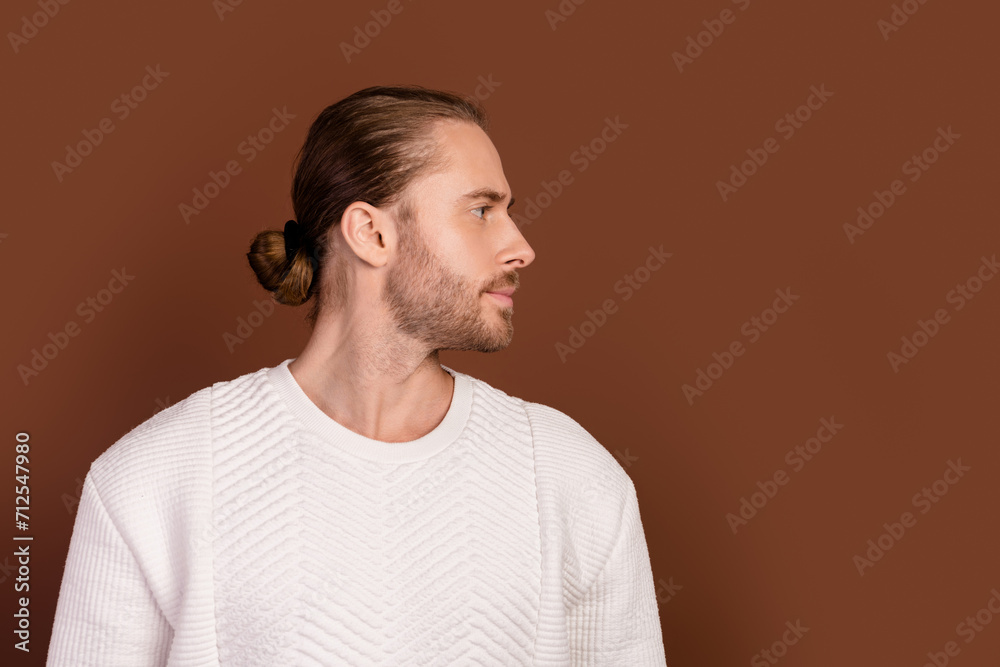 Photo of good mood cool guy dressed white pullover looking empty space isolated brown color background Photo of good mood cool guy dressed white pullover looking empty space isolated brown color background