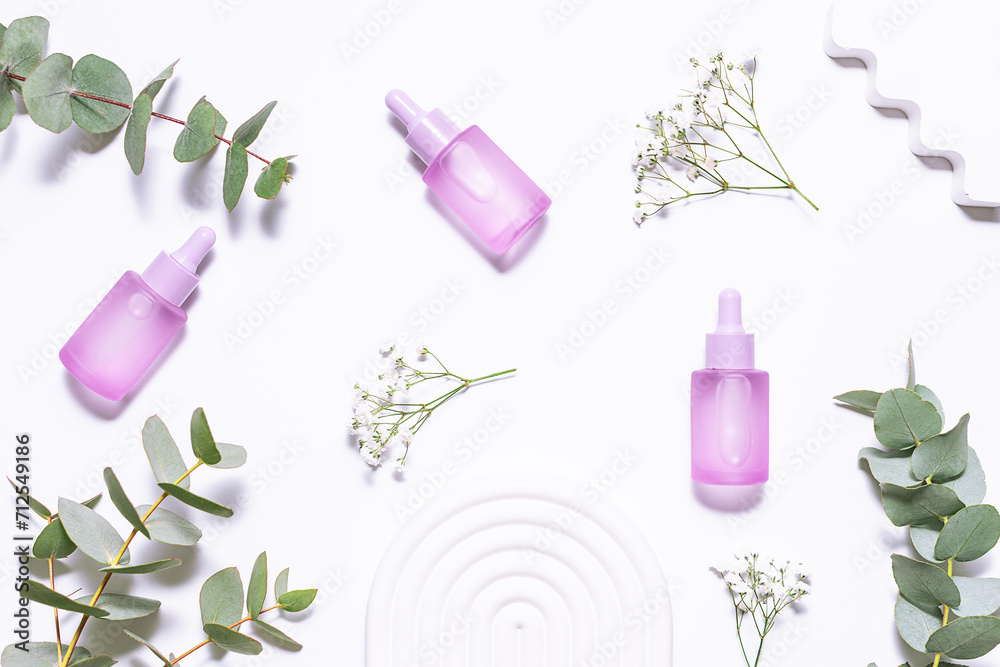 Set of organic eco skin care products in colorful unbranded containers , beautiful flowers and eucalyptus leaves on white background top view. Cosmetic branding concept. Set of organic eco skin care products in colorful unbranded containers , beautiful flowers and eucalyptus leaves on white background top view. Cosmetic branding concept.