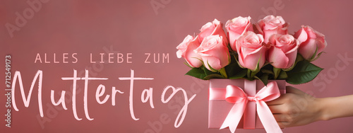 Alles Liebe zum Muttertag Feiertag Grußkarte mit deutschem Text - Mädchen hält Geschenkbox, Geschenk mit Rosen in ihren Händen, isoliert auf pinkem Hintergrund