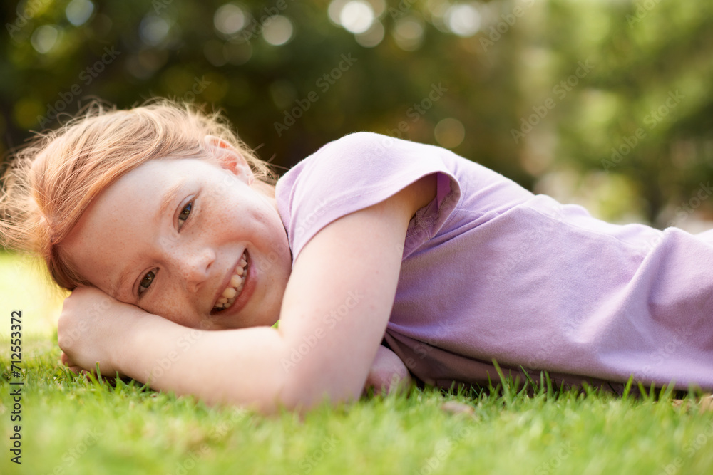 Happy, portrait and young girl on grass, relax outdoor for fun and rest in garden or backyard. Youth, free time and playing in park, field or environment with smile on face for summer vacation Happy, portrait and young girl on grass, relax outdoor for fun and rest in garden or backyard. Youth, free time and playing in park, field or environment with smile on face for summer vacation