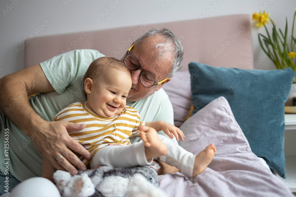 Grandfather and toddler sharing a joyful moment Grandfather and toddler sharing a joyful moment