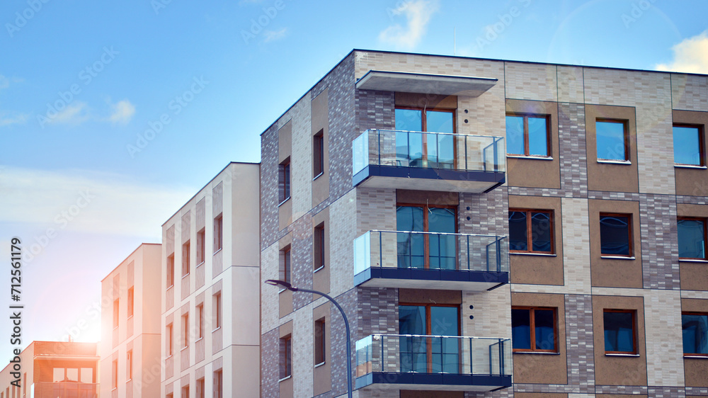 Modern apartment building in sunny day. Exterior, residential house facade. Residential area with modern, new and stylish living block of flats. 