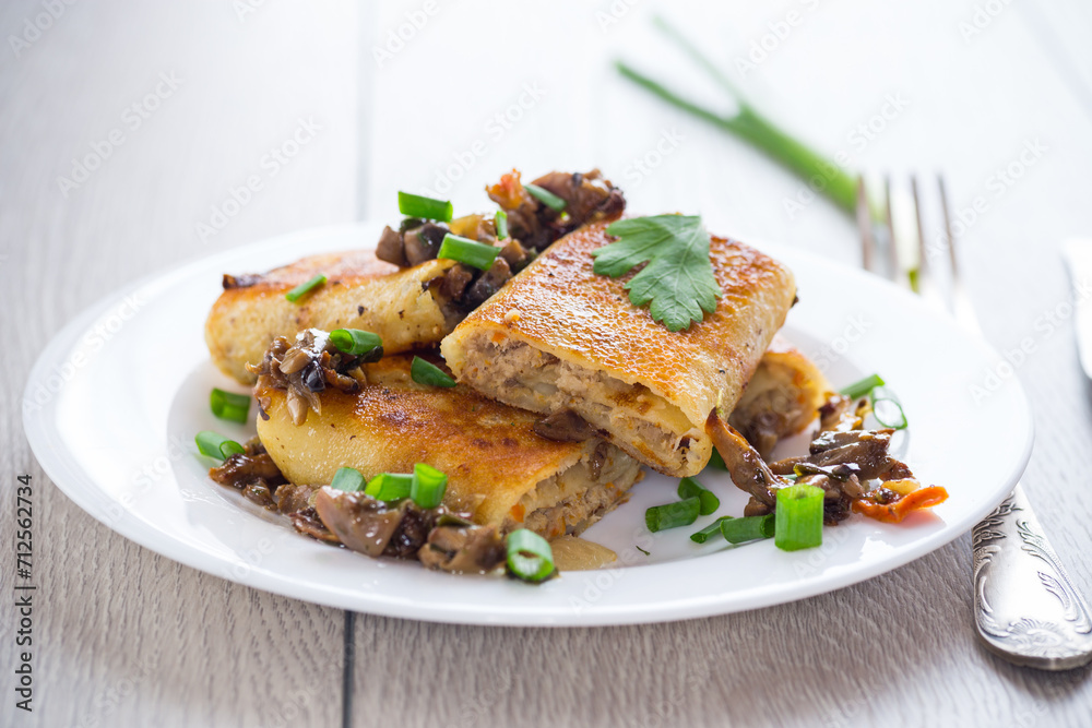 fried thin pancakes stuffed with meat and mushrooms.